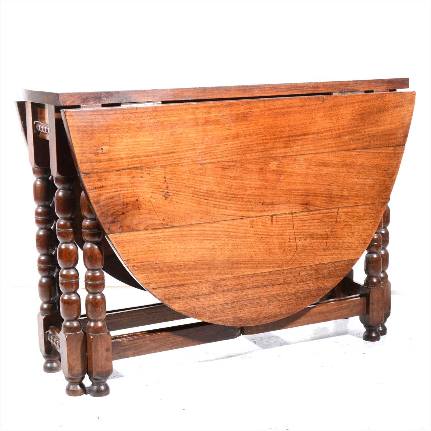 Lot 447 - A mahogany topped joined oak gateleg table