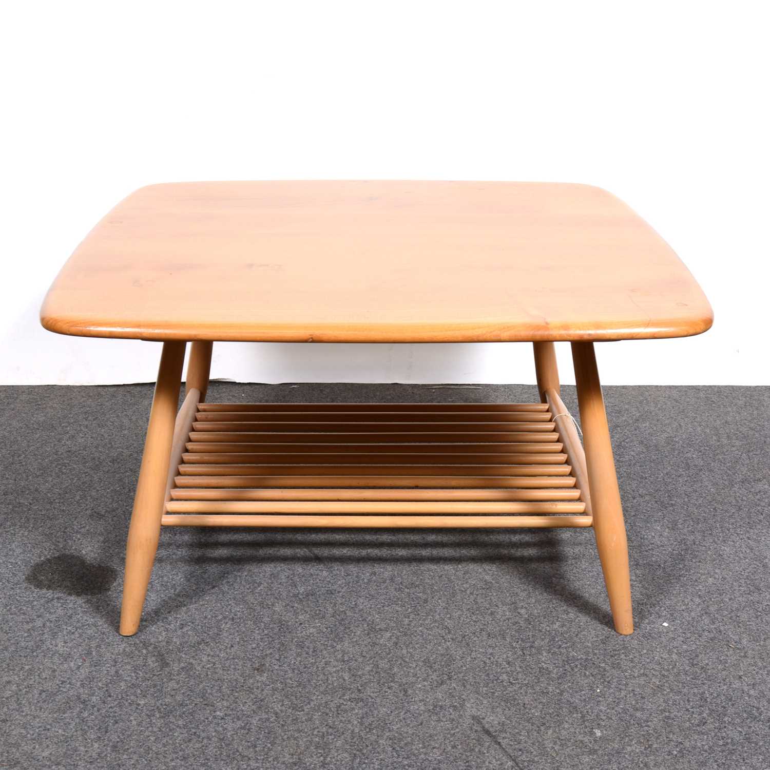 Lot 8 - An Ercol coffee table with magazine undertier