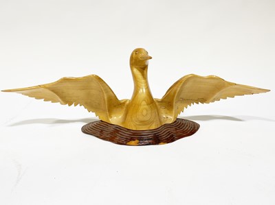 Lot 664 - A carved satinwood sculpture of a bird with outstretched wings, contemporary craft