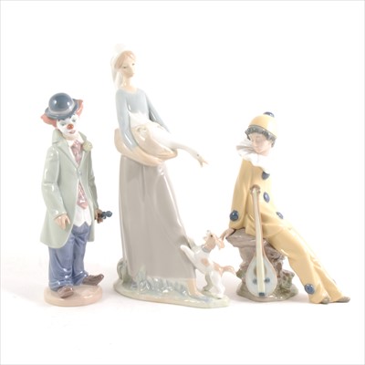 Lot 2 - A Lladro figure of a clown and violin, and two Nao figures.