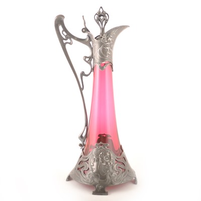 Lot 603 - An Art Nouveau pewter and cranberry glass claret jug, by WMF