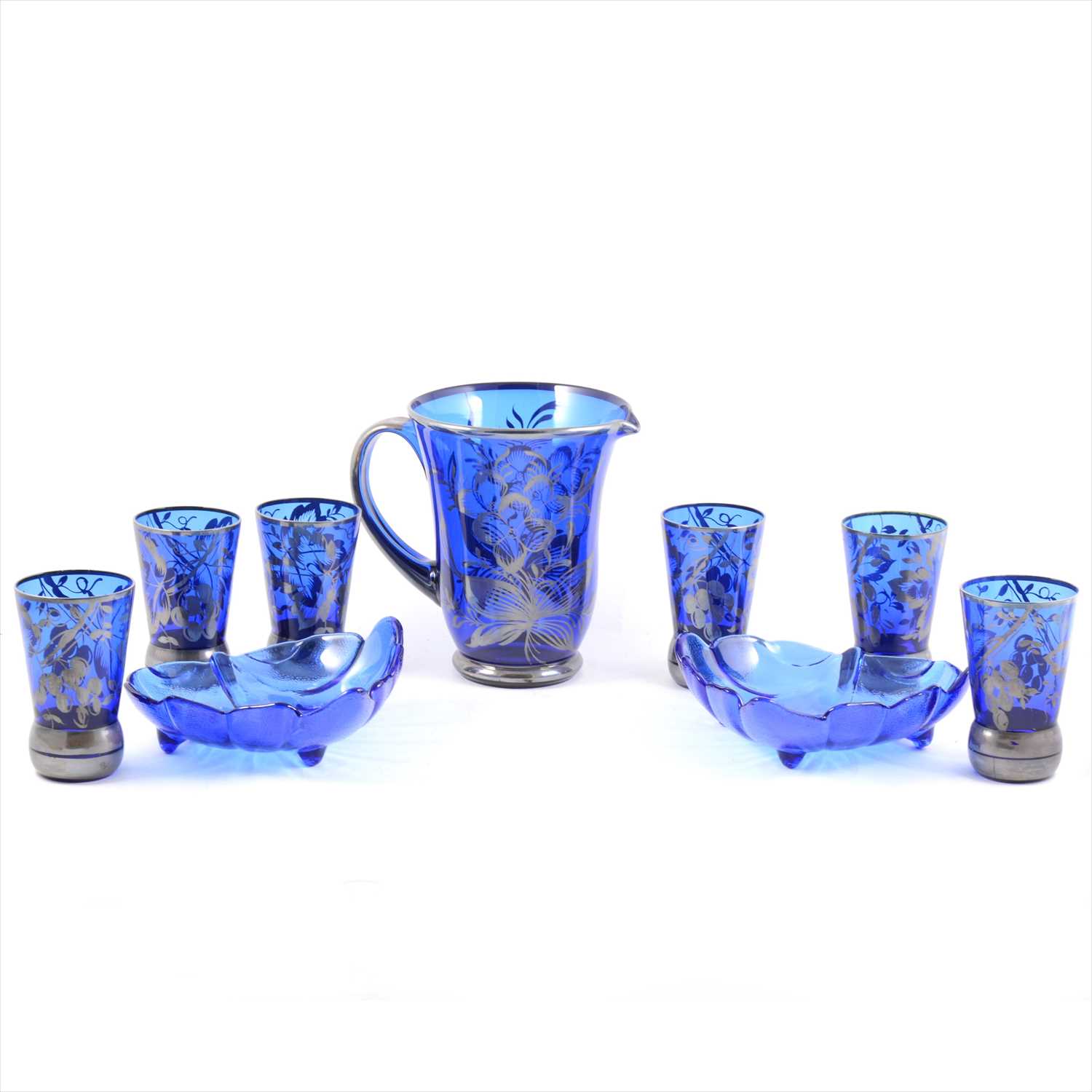 Lot 28 - A 1920s blue glass lemonade jug and set of six tumblers, silvered overlay, two modern blue glass dishes.