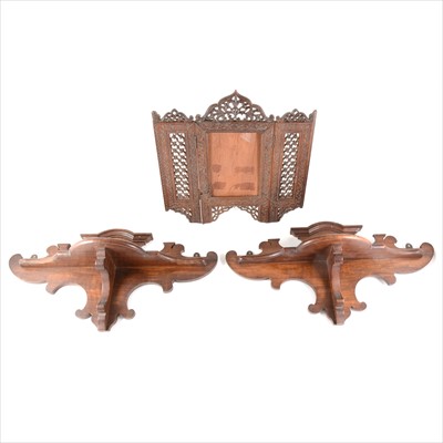Lot 117 - Two mahogany wall brackets and a folding Indian carved photograph frame.