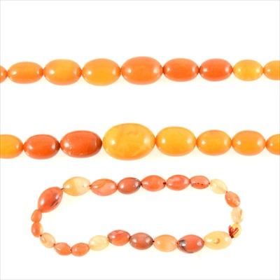 Lot 234 - Two amber coloured bead necklaces and agate beads.