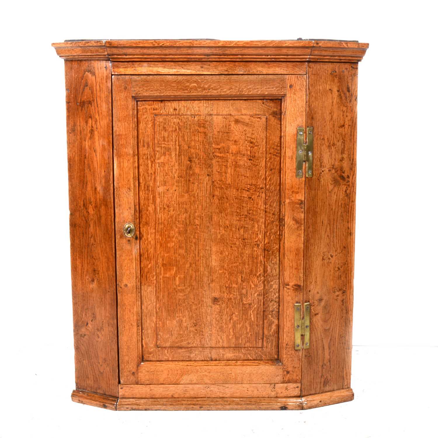 Lot - A George III oak corner cupboard