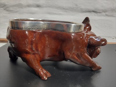 Lot 10 - A Royal Doulton treacle glazed pig dish modelled by Charles Noke.