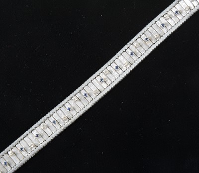 Lot 80 - An 18 carat white gold bracelet set with sapphires and diamonds.