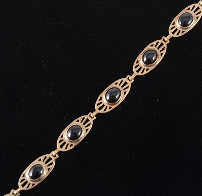 Lot 92 - A 9 carat rose gold garnet set bracelet.