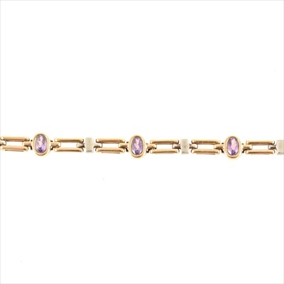 Lot 227 - A 9 carat yellow and white gold bracelet collet set with six oval mixed cut amethyst.