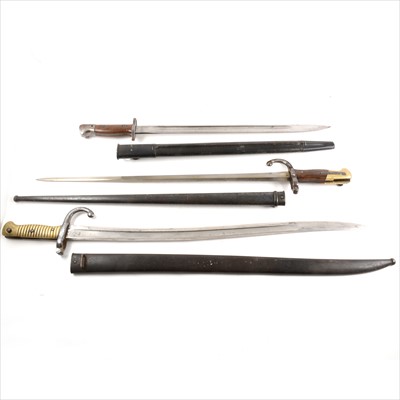Lot 93 - Three bayonets, one First World War British, two St Etienne. 1871 and 1879.