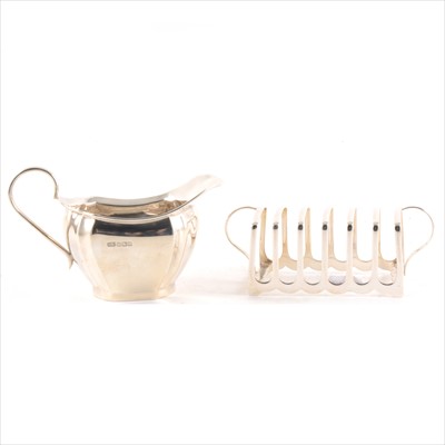 Lot 157 - A silver milk jug, Viner's, Sheffield 1930, and a six-section toast rack