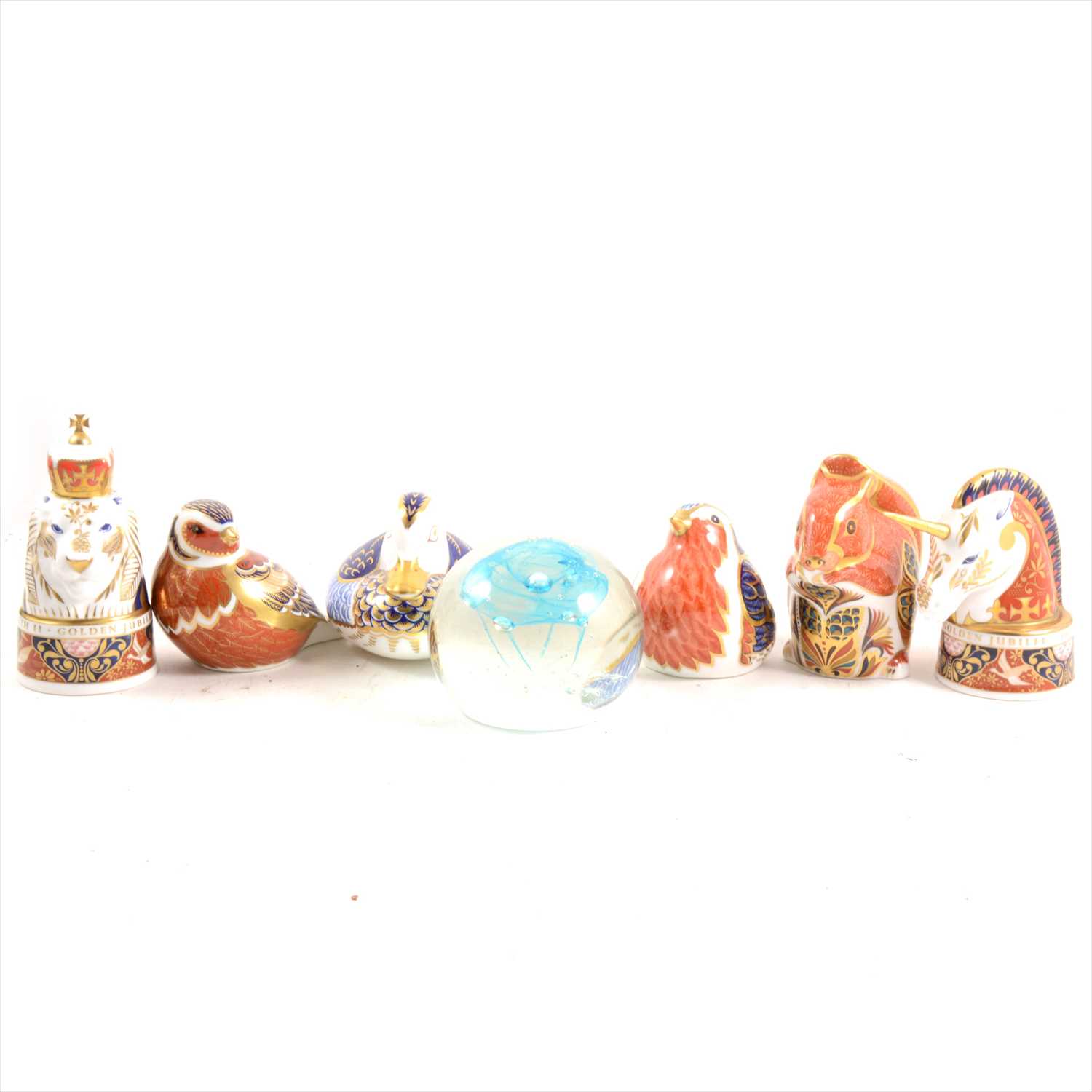 Lot 30 - Four Royal Crown Derby paperweights, pair of Worcester Lion and Unicorn candle snuffers, and a Caithness paperweight.
