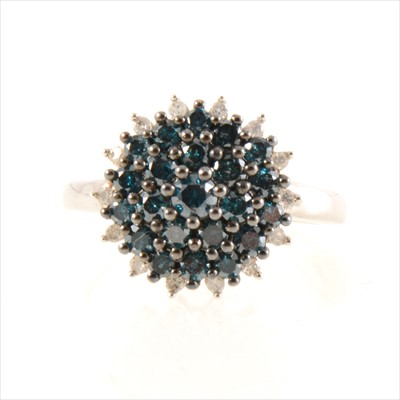 Lot 193 - A circular blue and white diamond cluster ring.