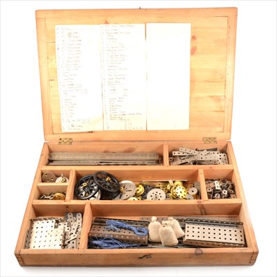 Lot 108 - Meccano; a collection of mostly 1920s nickel plated parts, brass gears and pinions, spoked wheels, in wooden case.