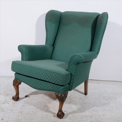 Lot 396 - A reproduction wing-back easychair