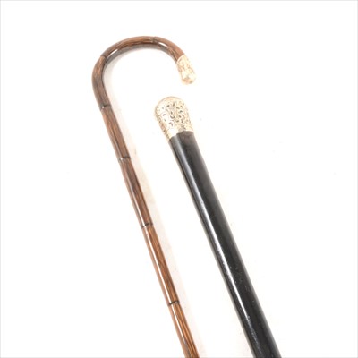 Lot 223 - An Edwardian ebonised walking cane with a silver pommel, London 1909...