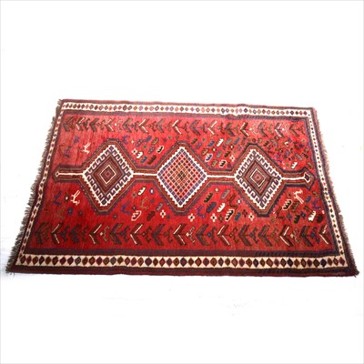 Lot 348 - A Persian carpet with three lozenge medallions, strawberry field