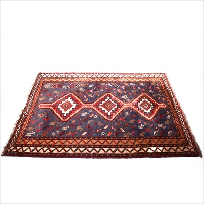 Lot 347 - A Persian carpet with three lozenge medallions, deep blue field