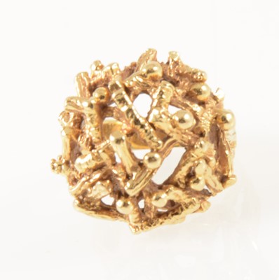 Lot 43 - A yellow metal dress ring, domed textured twig design.