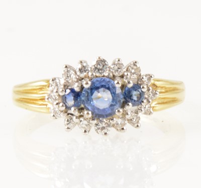 Lot 20 - A sapphire and diamond boat shape cluster ring.