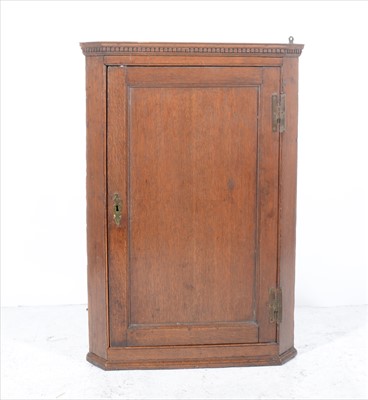 Lot 290 - George III oak hanging corner cupboard