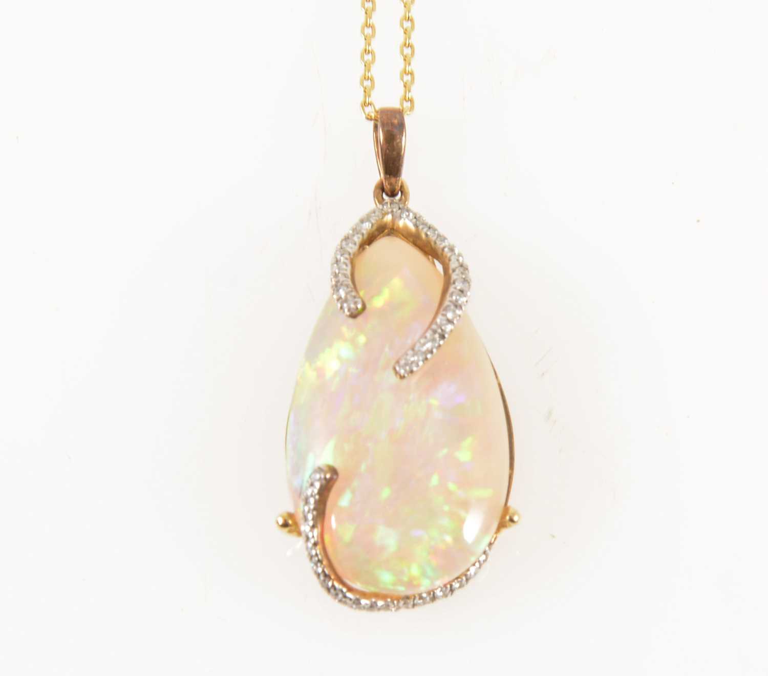 Lot 123 - An opal and diamond pendant and chain