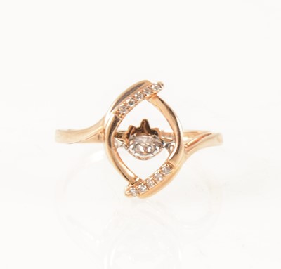 Lot 1259 - A dancing diamond dress ring.