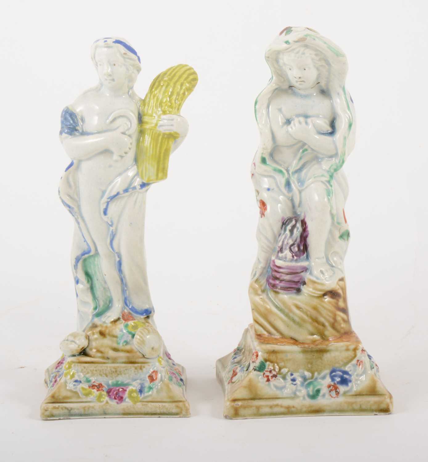 Lot 6 - Two pearlware figures, emblematic of Autumn and Winter, late 18th century