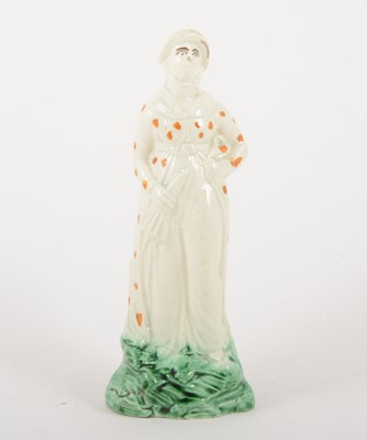 Lot 69 - A creamware figure of a lady, late 18th century
