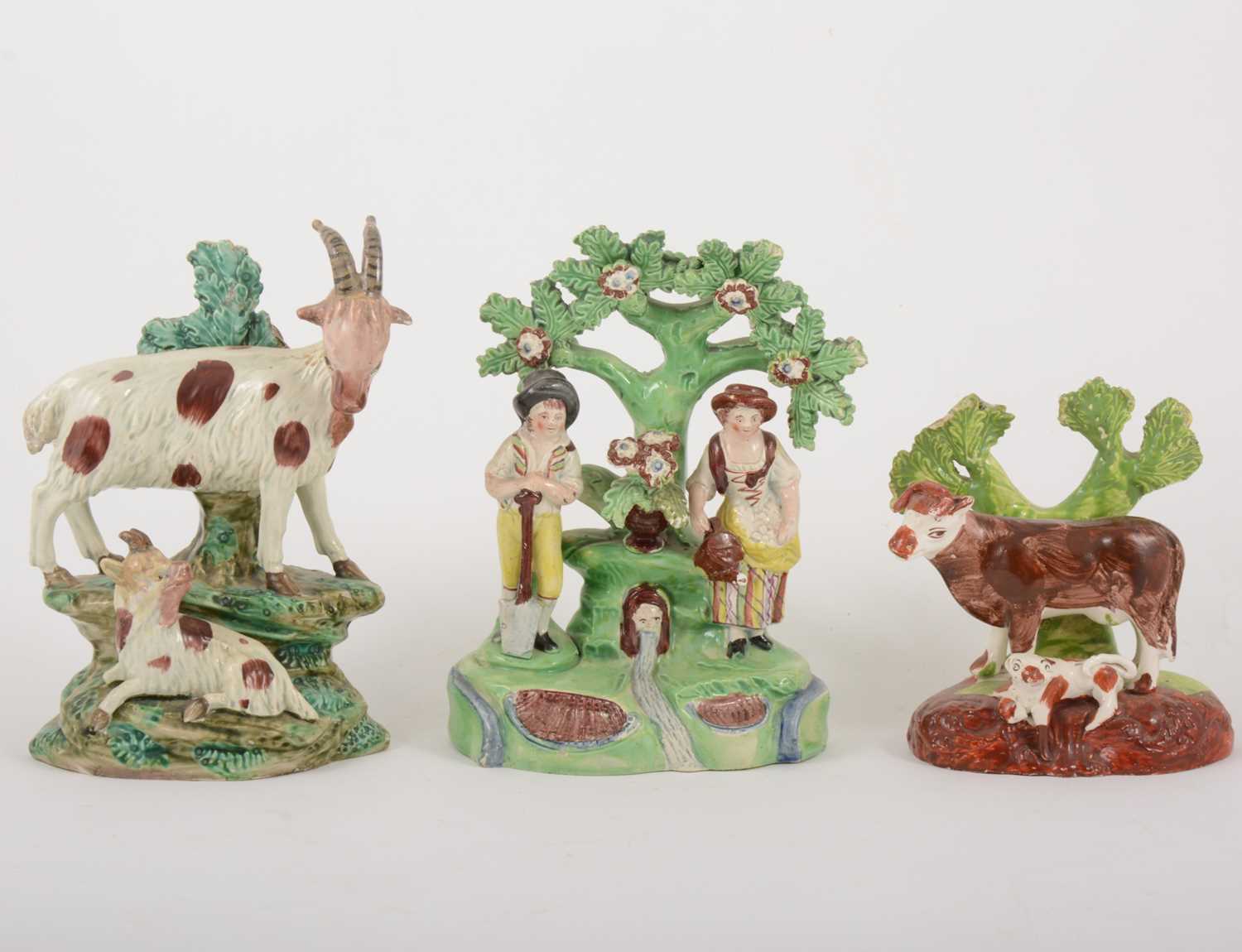 Lot 11 - A Staffordshire pearl glazed earthenware group, gardeners by a fountain, early 19th century, and two bocage groups