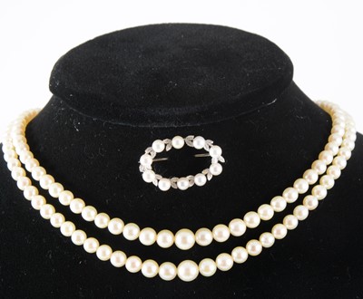 Lot 346 - A cultured pearl two row necklace and pearl set brooch.