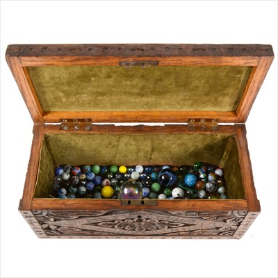 Lot 166 - 19th Century carved oak box containing a quantity of glass marbles.
