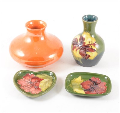 Lot 96 - Moorcroft orange lustre vase, squat form, and three Hibiscus pattern items