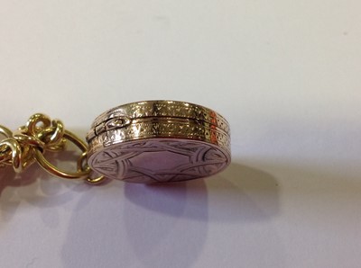 Lot 90 - An 18 carat yellow gold link bracelet with fob attached.