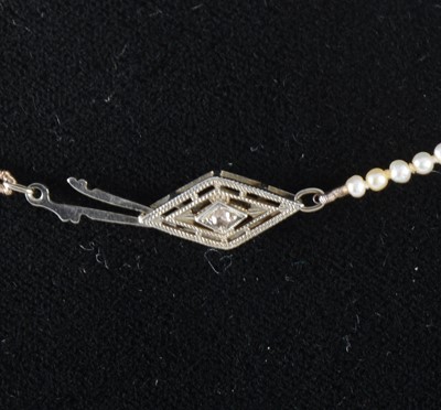 Lot 345 - A pearl necklace with diamond set clasp.