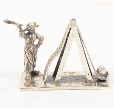 Lot 280A - A small modern silver model of a carpet beater.