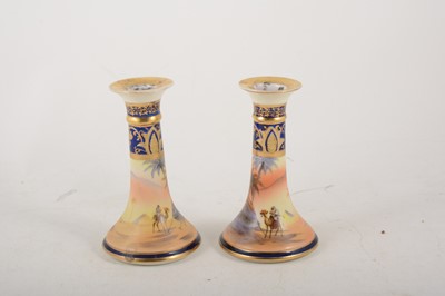 Lot 1002 - A pair of Noritake porcelain candlesticks