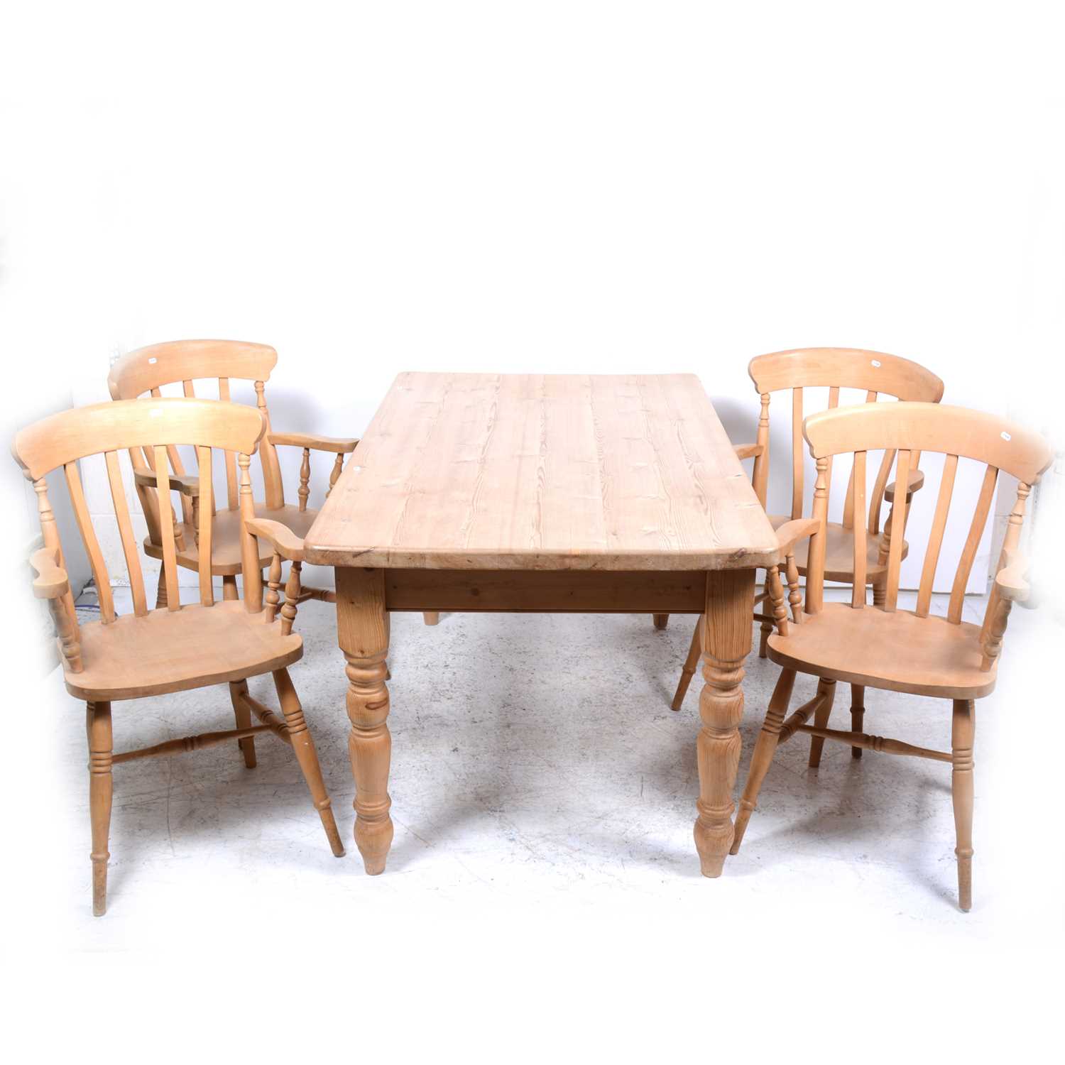 Lot 54 - A modern pine kitchen table and four beechwood elbow chairs