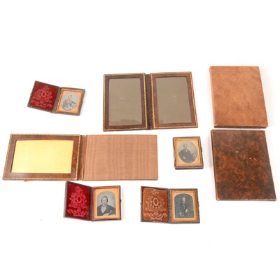 Lot 164 - Four ambrotype photographs, each cased, and four folding leather photograph sleeves