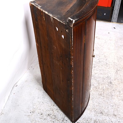 Lot 18 - A George III oak and mahogany cylinder front hanging corner cupboard