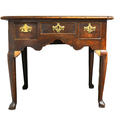 Lot 1546 - A George III oak lowboy