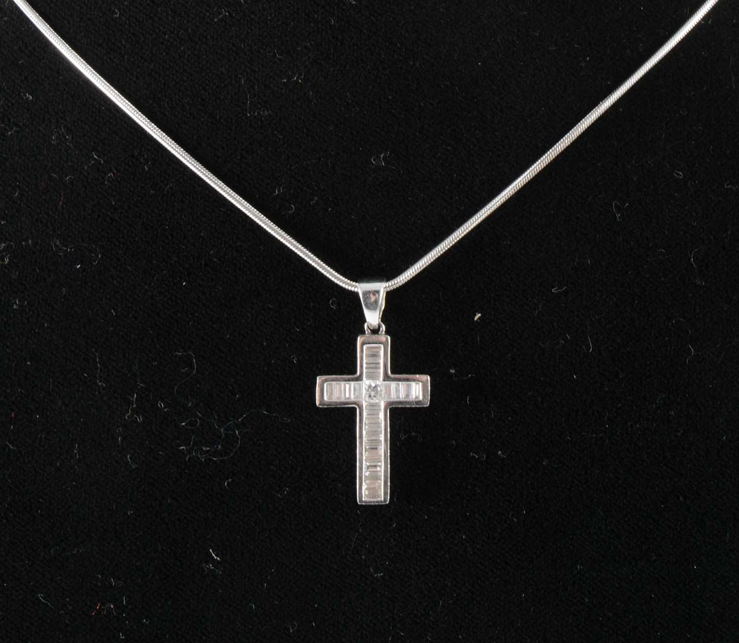 Lot 119 - A diamond cross on chain.