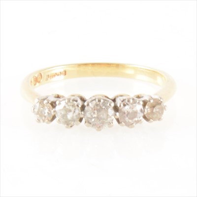 Lot 1251 - A diamond five stone ring.