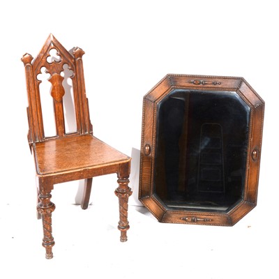 Lot 386 - A Victorian oak hall chair in the Gothic style, and an oak framed mirror