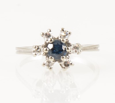 Lot 352 - A sapphire and diamond circular cluster ring.