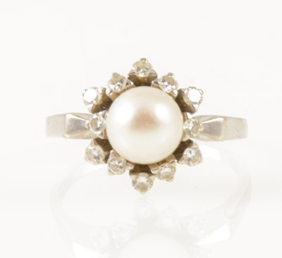 Lot 1271 - A pearl and diamond circular cluster dress ring.