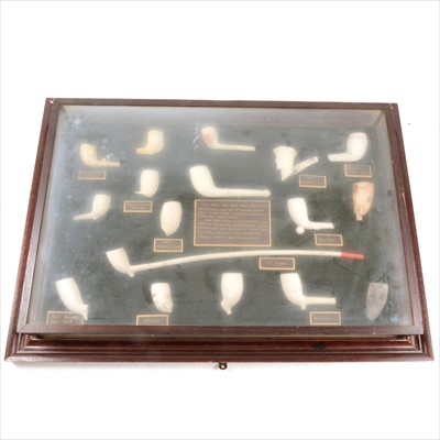 Lot 127 - A framed collection of clay pipes, papier mache lidded pot, Victorian Bully Beef tin opener