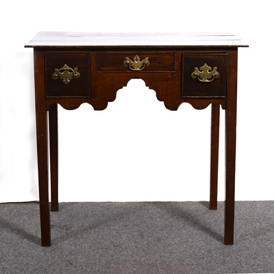 Lot 1587 - A George III oak lowboy