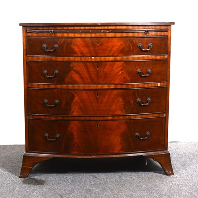 Lot 1545 - A reproduction mahogany bowfront bachelor's chest in the Georgian style