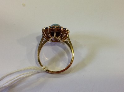 Lot 38 - A black opal and sapphire dress ring.